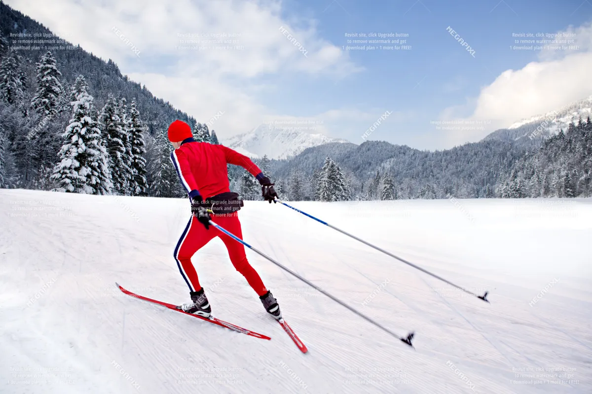 This exterior image features a skier in bright red attire gliding across a snow-covered landscape, backed by scenic mountains. The setting is energetic and captures the thrill of winter sports in a beautiful natural environment.